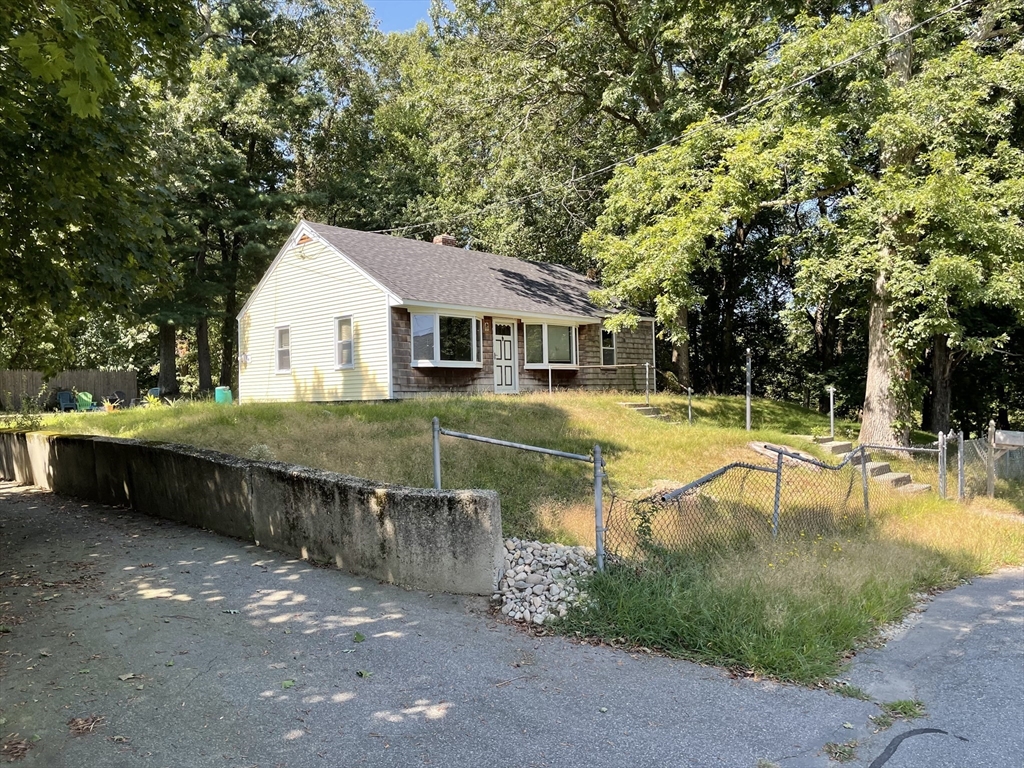 a view of a house with swimming pool and sitting area