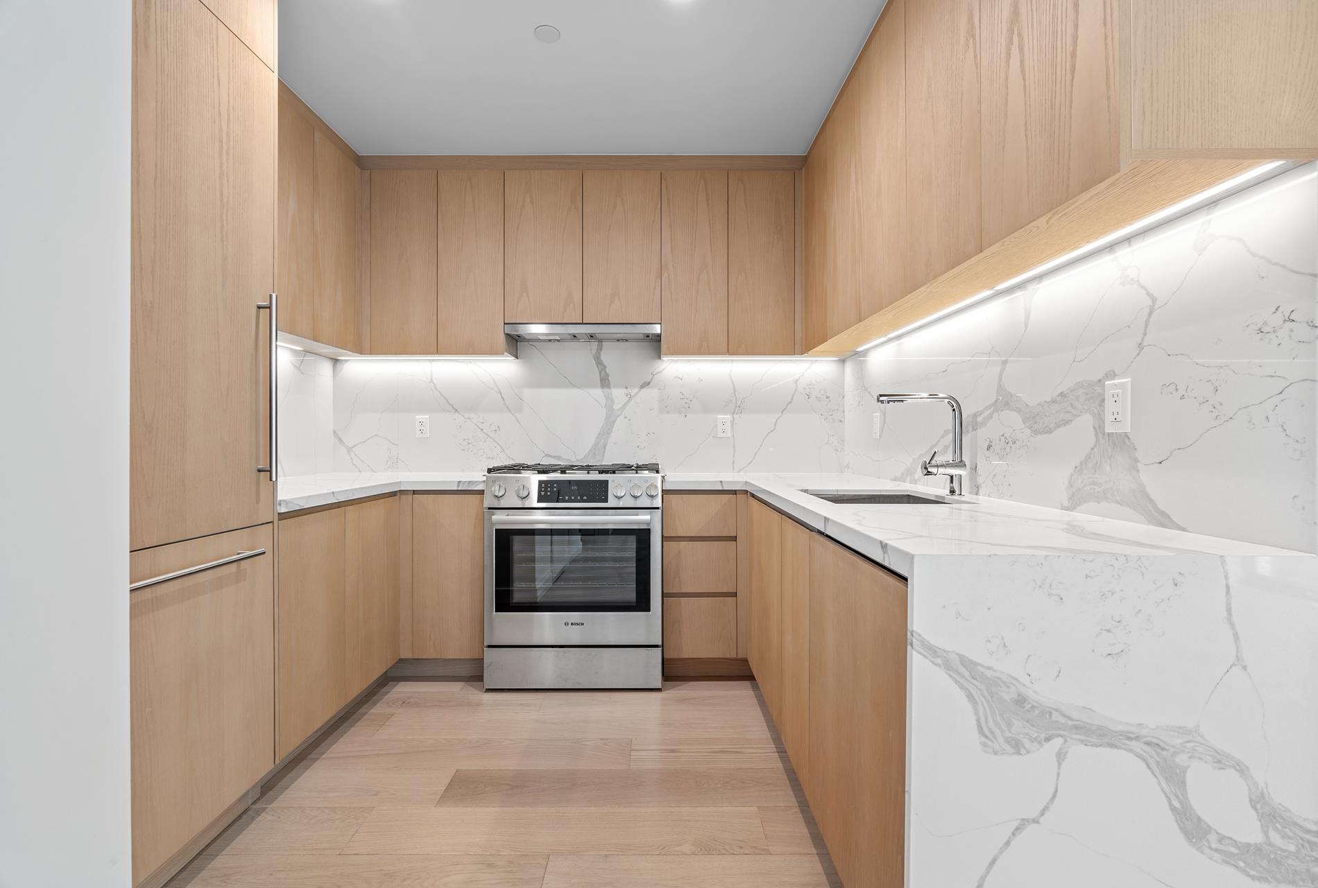 a kitchen with a sink stove and refrigerator