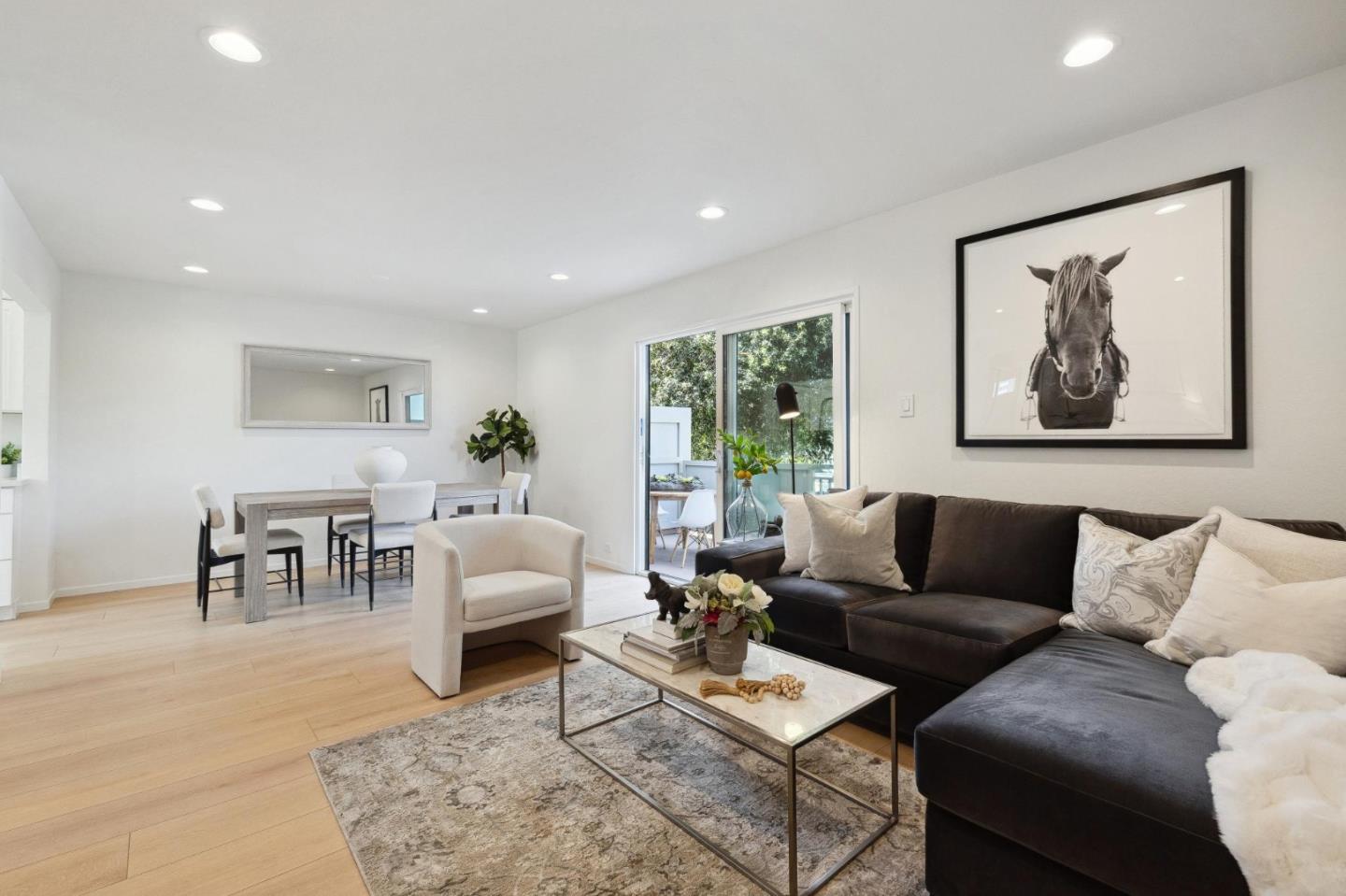 a living room with furniture and a painting on the wall