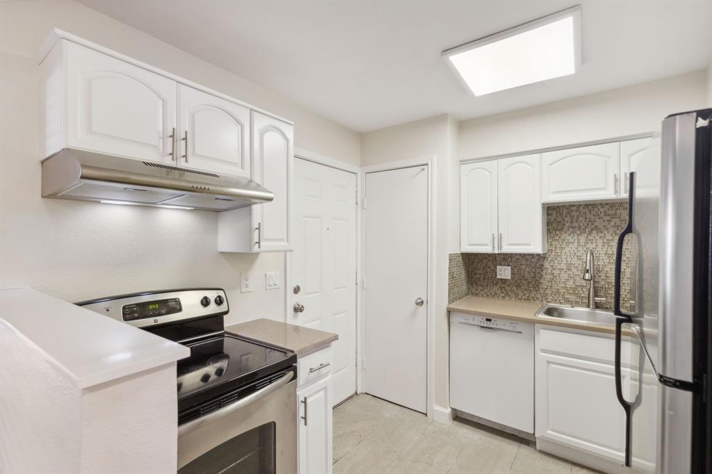 a kitchen with cabinets and appliances