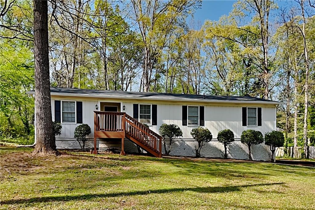 a front view of house with yard having outdoor seating