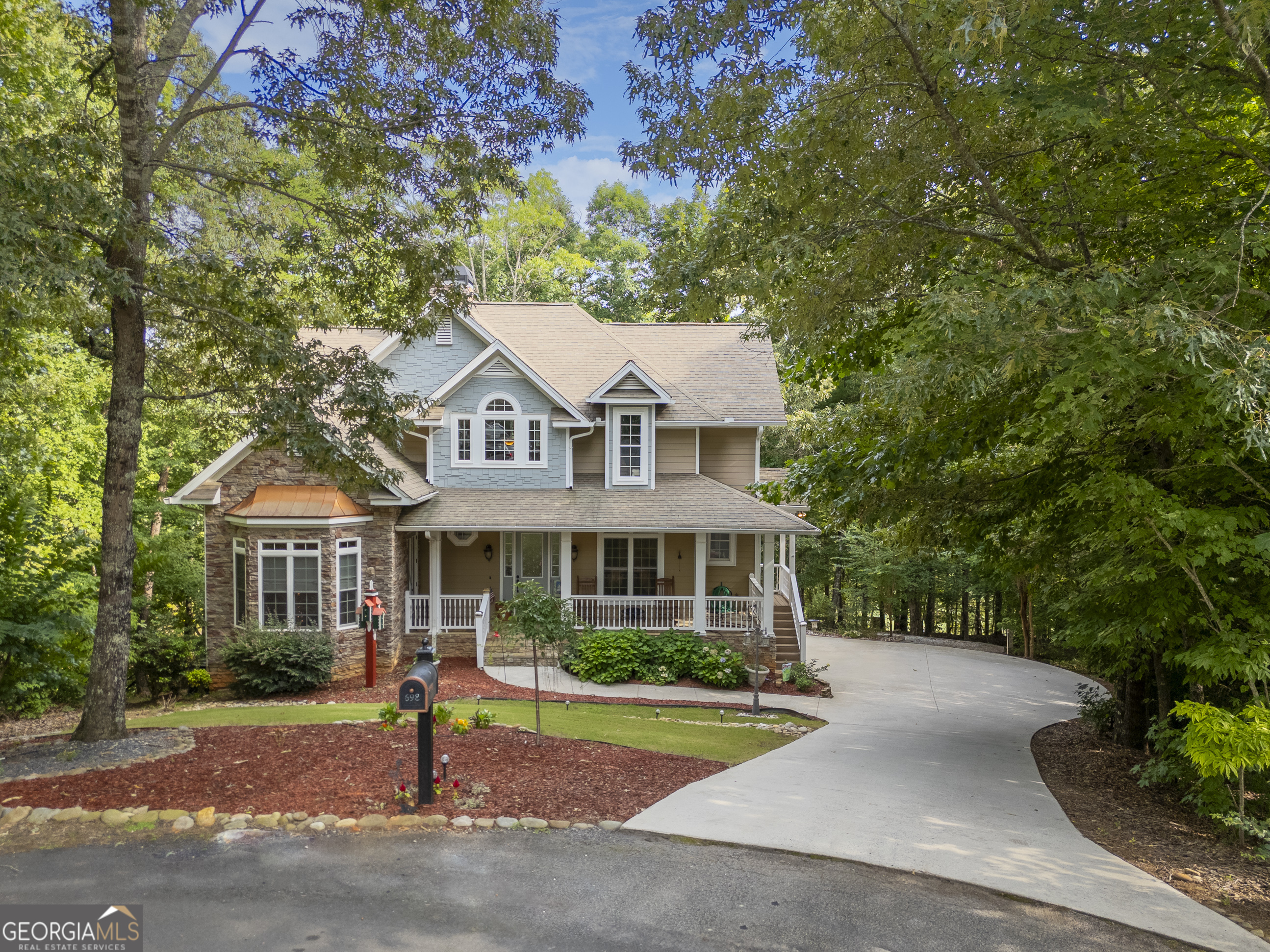 a front view of a house with a garden