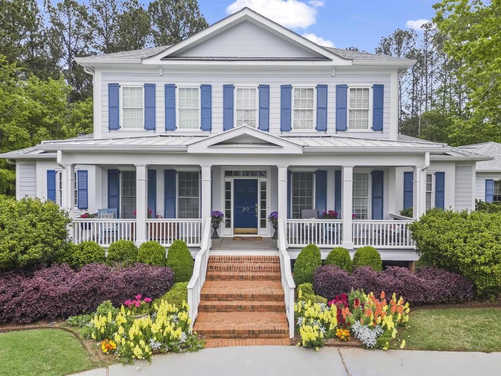 front view of a brick house with a yard