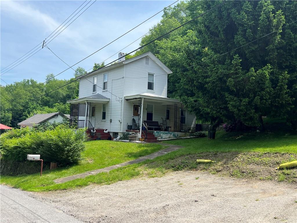 a view of a house with a yard porch and sitting area