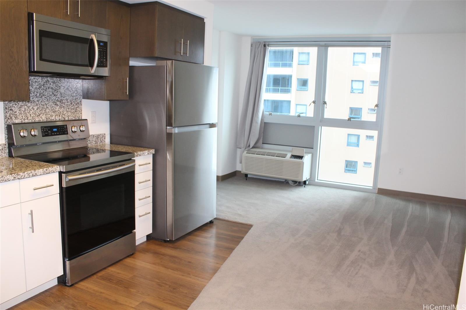 a kitchen with a refrigerator stove and microwave