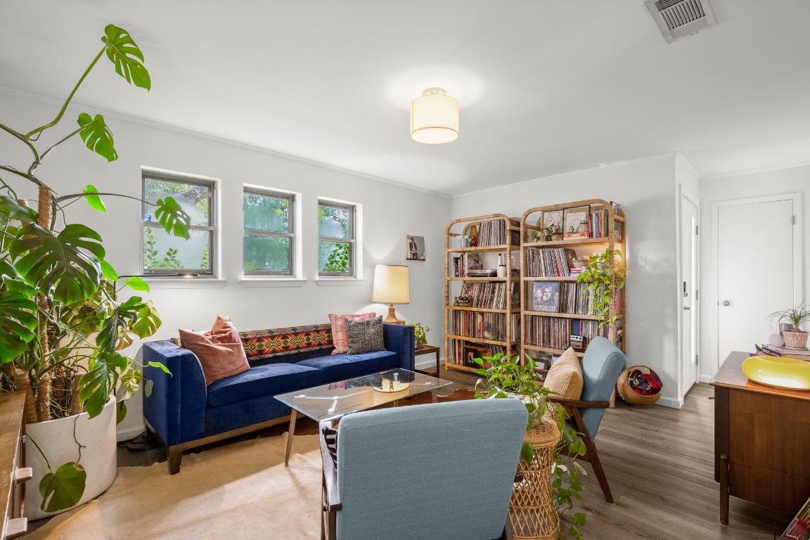 a living room with furniture a lamp and a potted plant