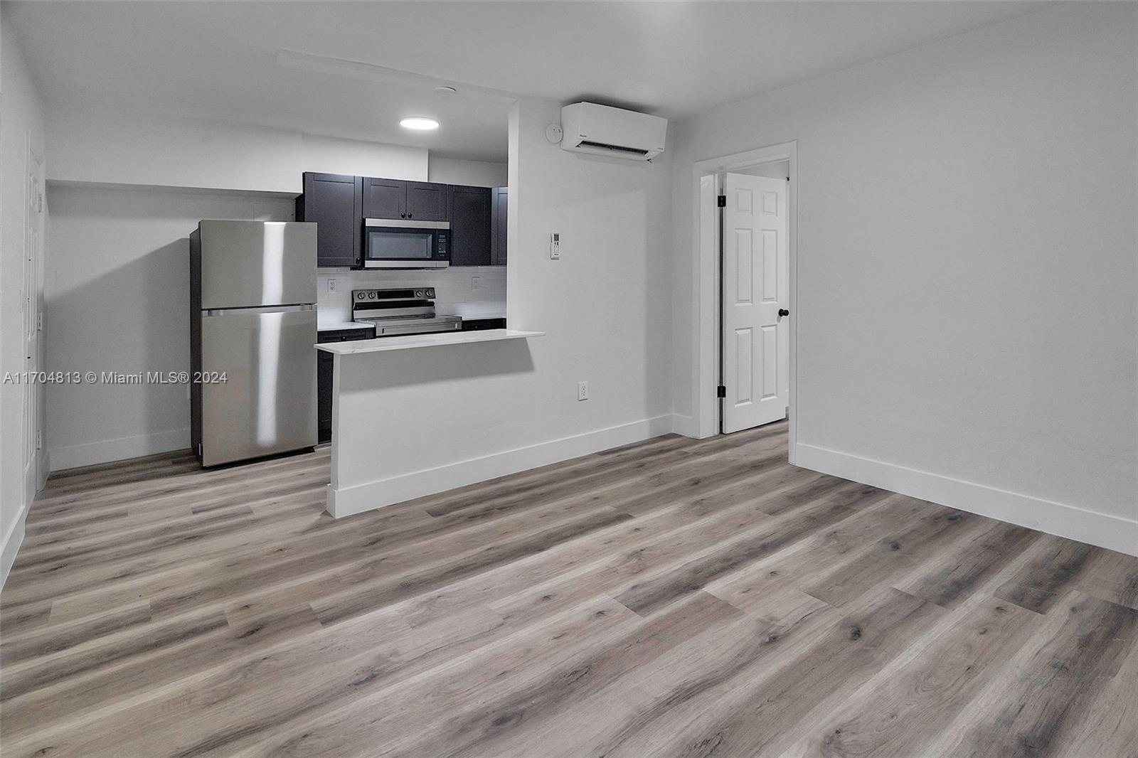 a view of kitchen view wooden floor and electronic appliances