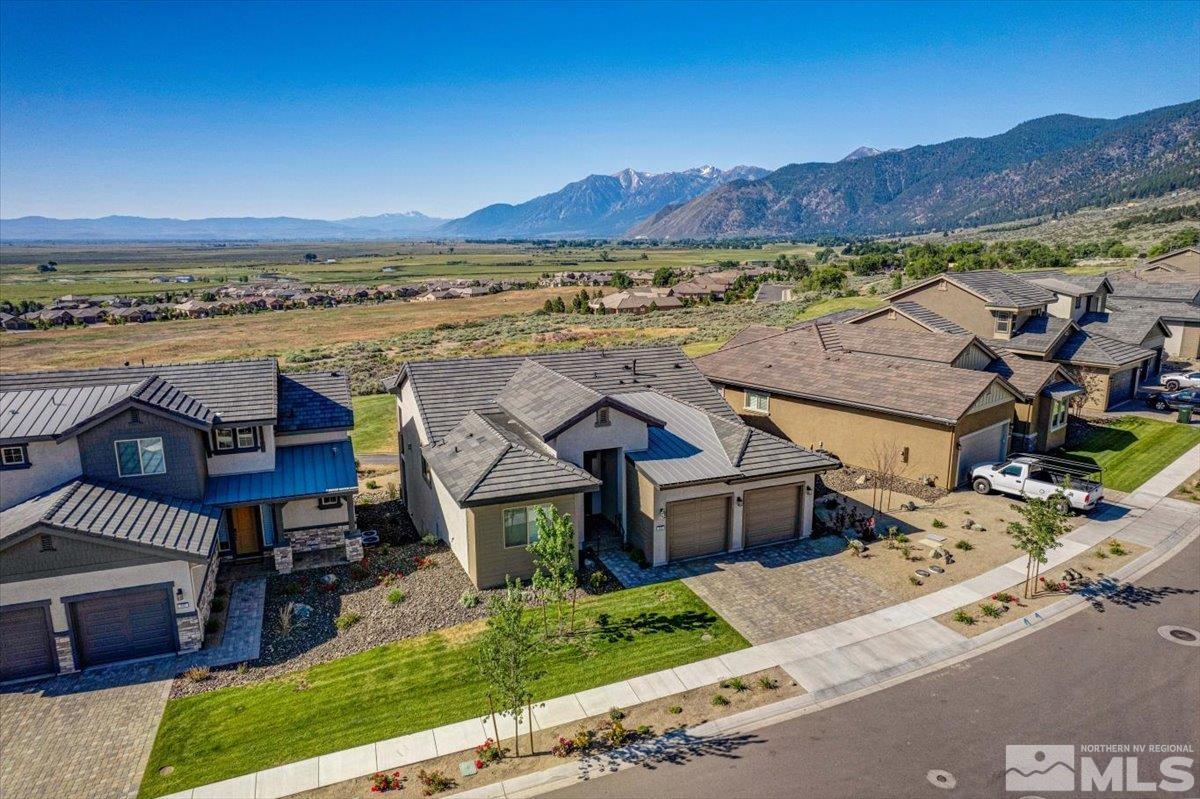 an aerial view of residential houses with outdoor space and ocean view