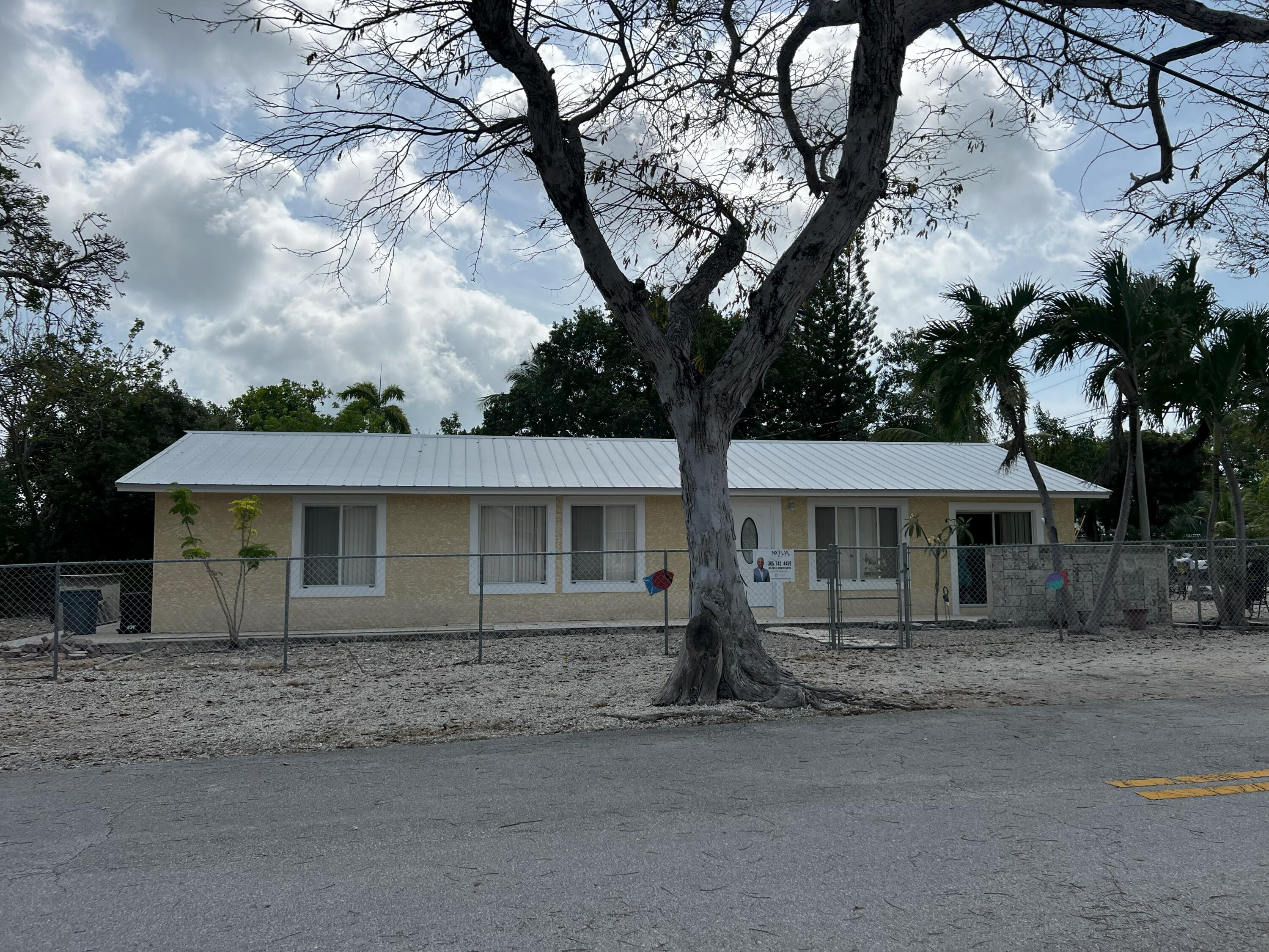 front view of a house with a tree