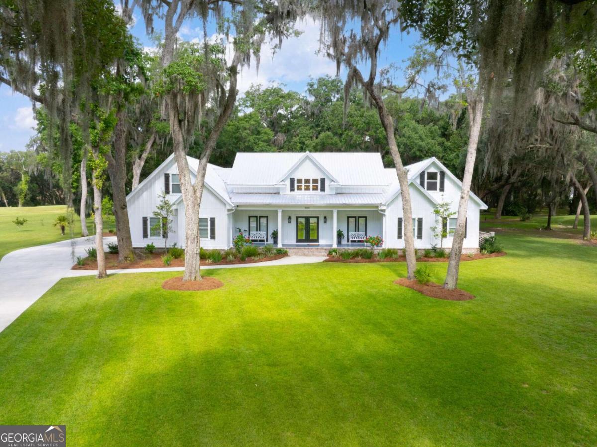 a aerial view of a house with swimming pool and porch