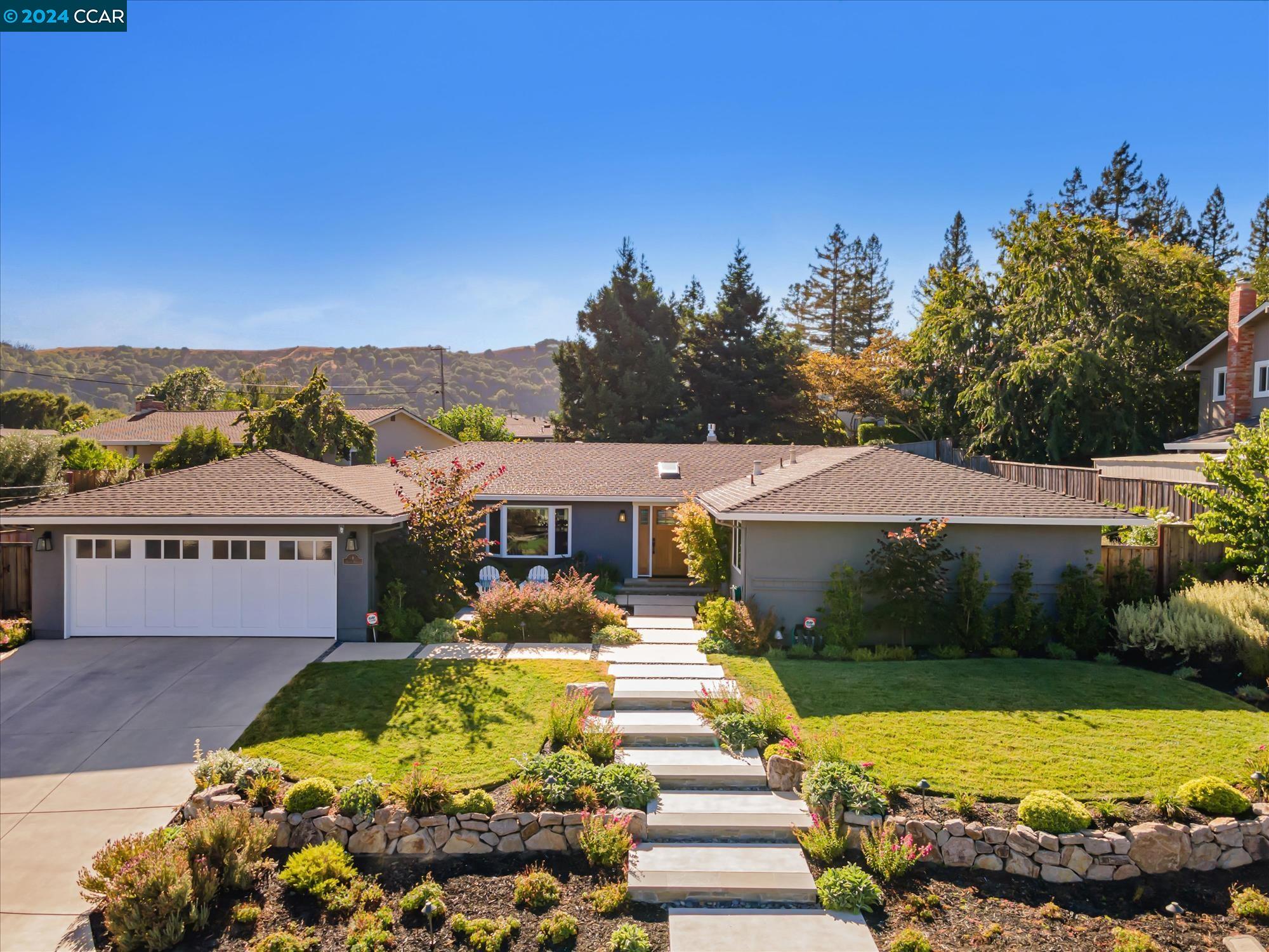 a front view of a house with a big yard