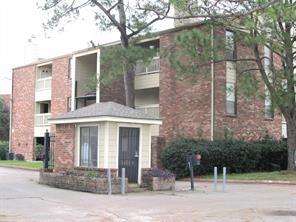 front view of a brick house with a yard