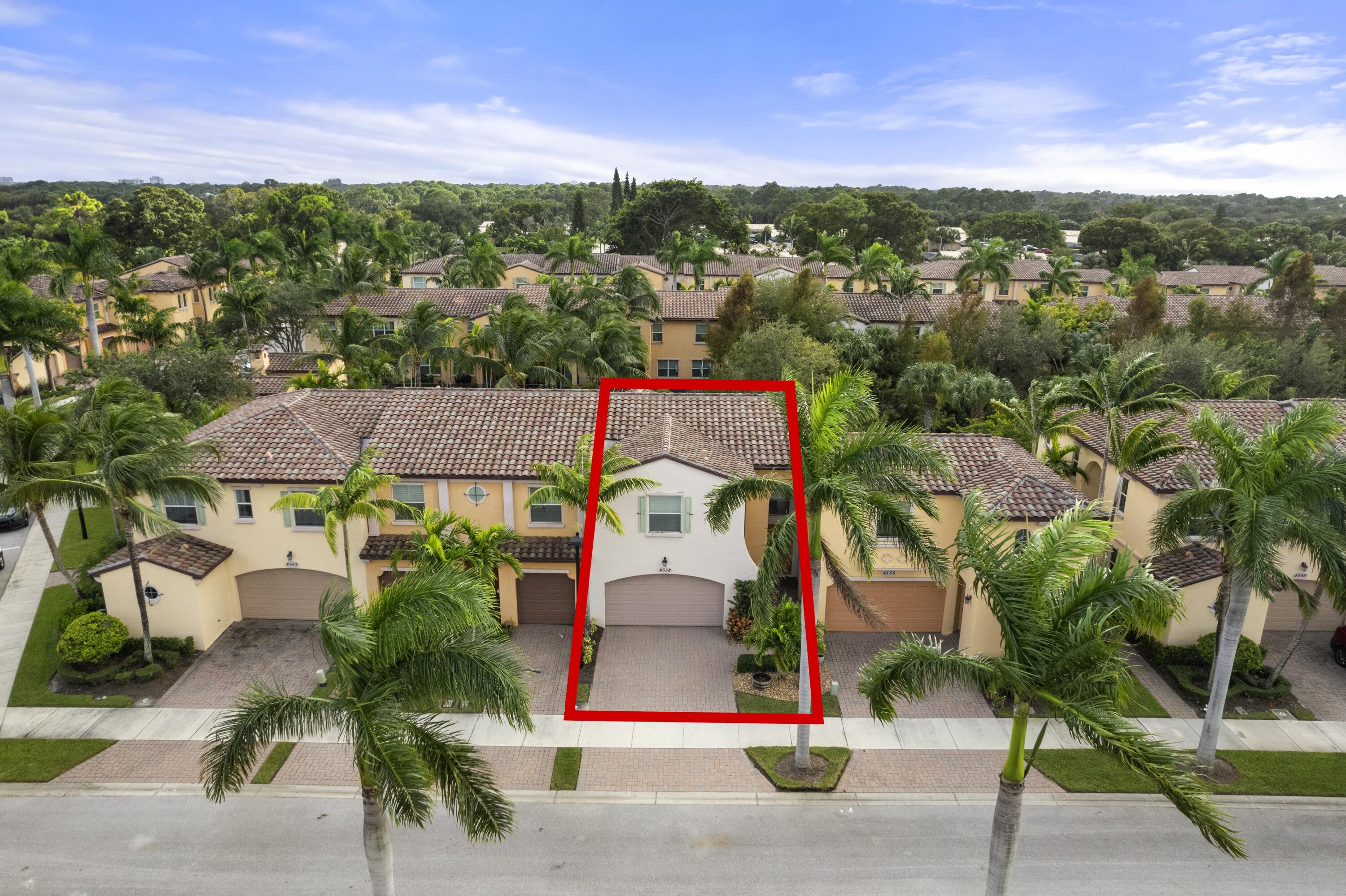 an aerial view of residential houses with outdoor space and street view