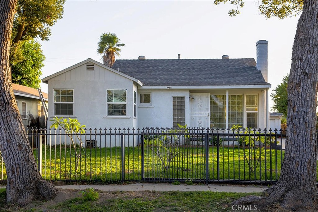 a view of house with a yard and a garden