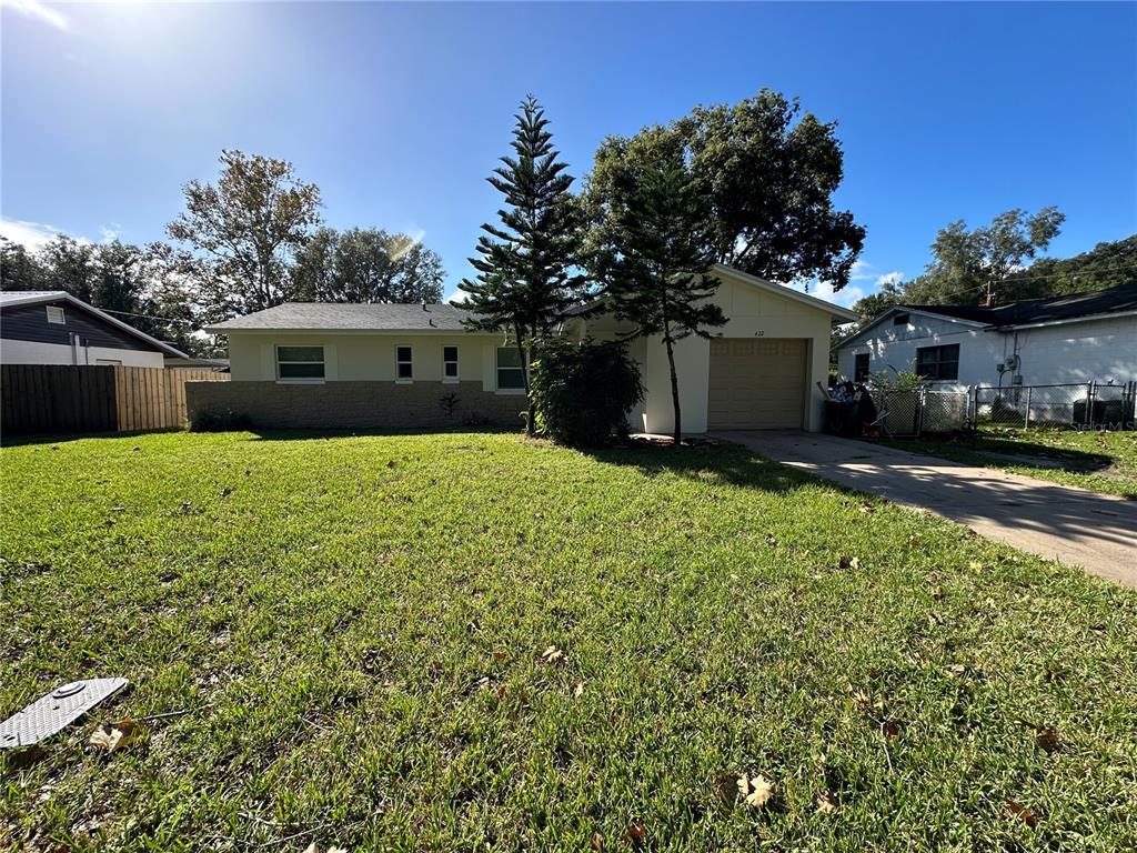 a view of a house with a yard and garage