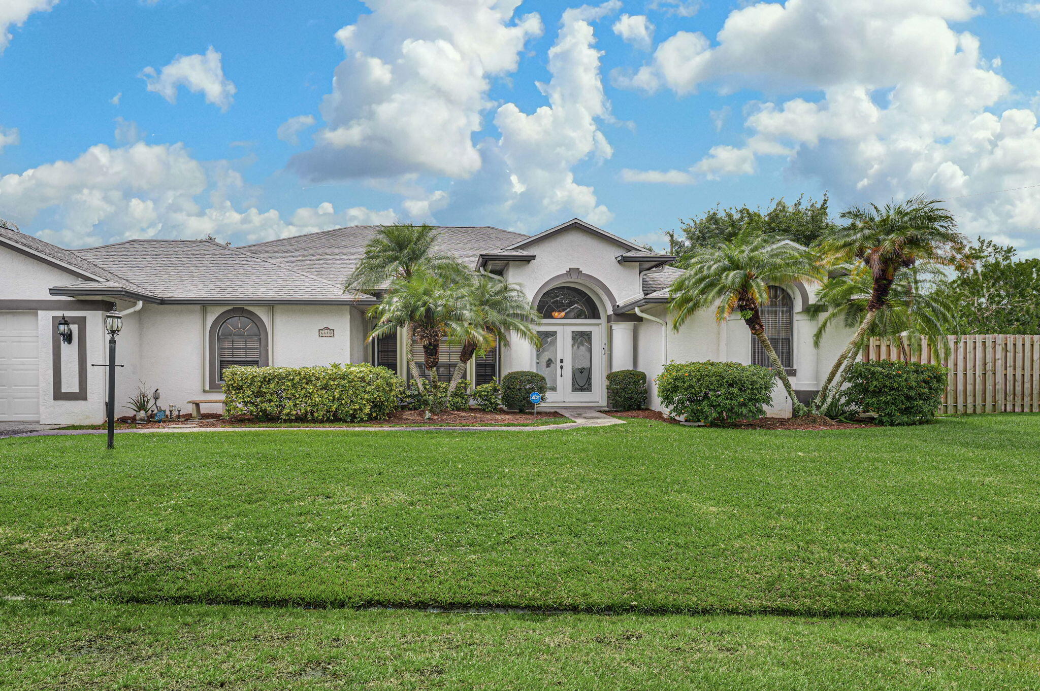 a front view of a house with garden