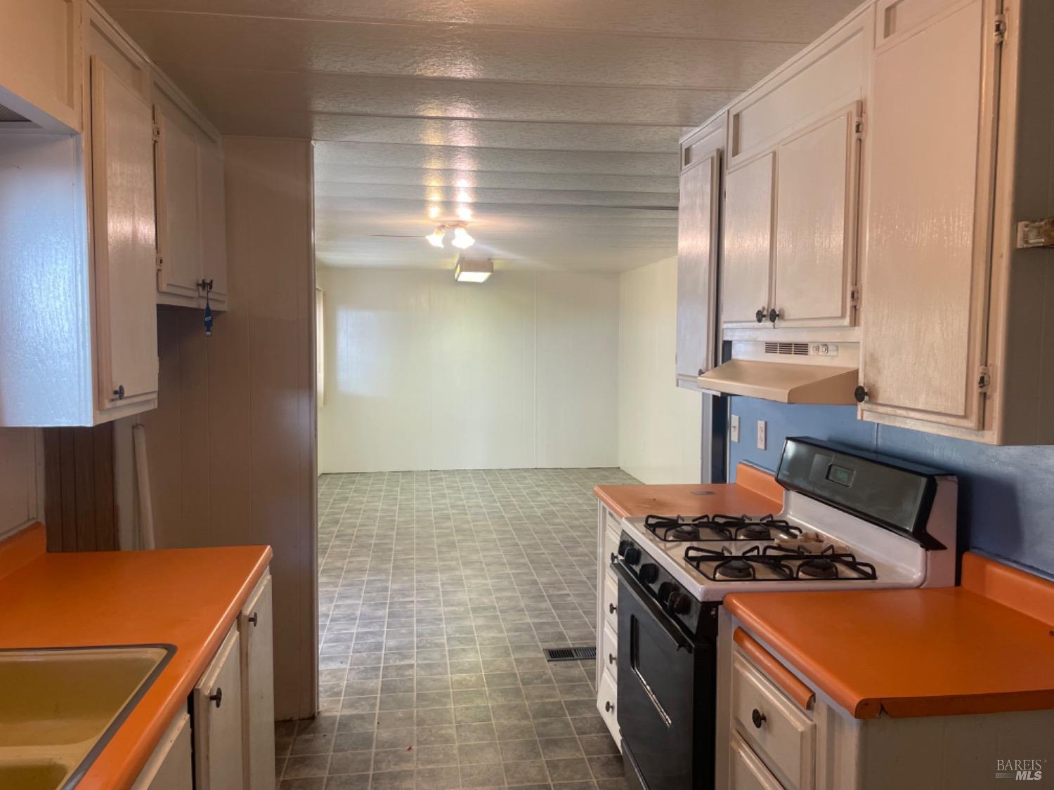 a kitchen with a stove and a refrigerator