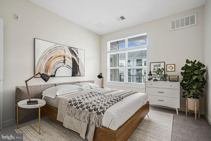 a bedroom with a bed and a potted plant