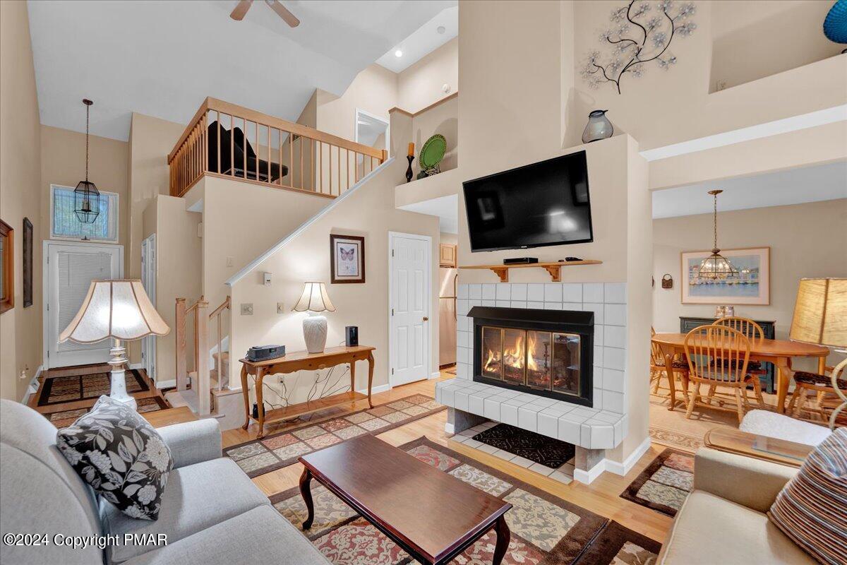 a living room with furniture a flat screen tv and a fireplace