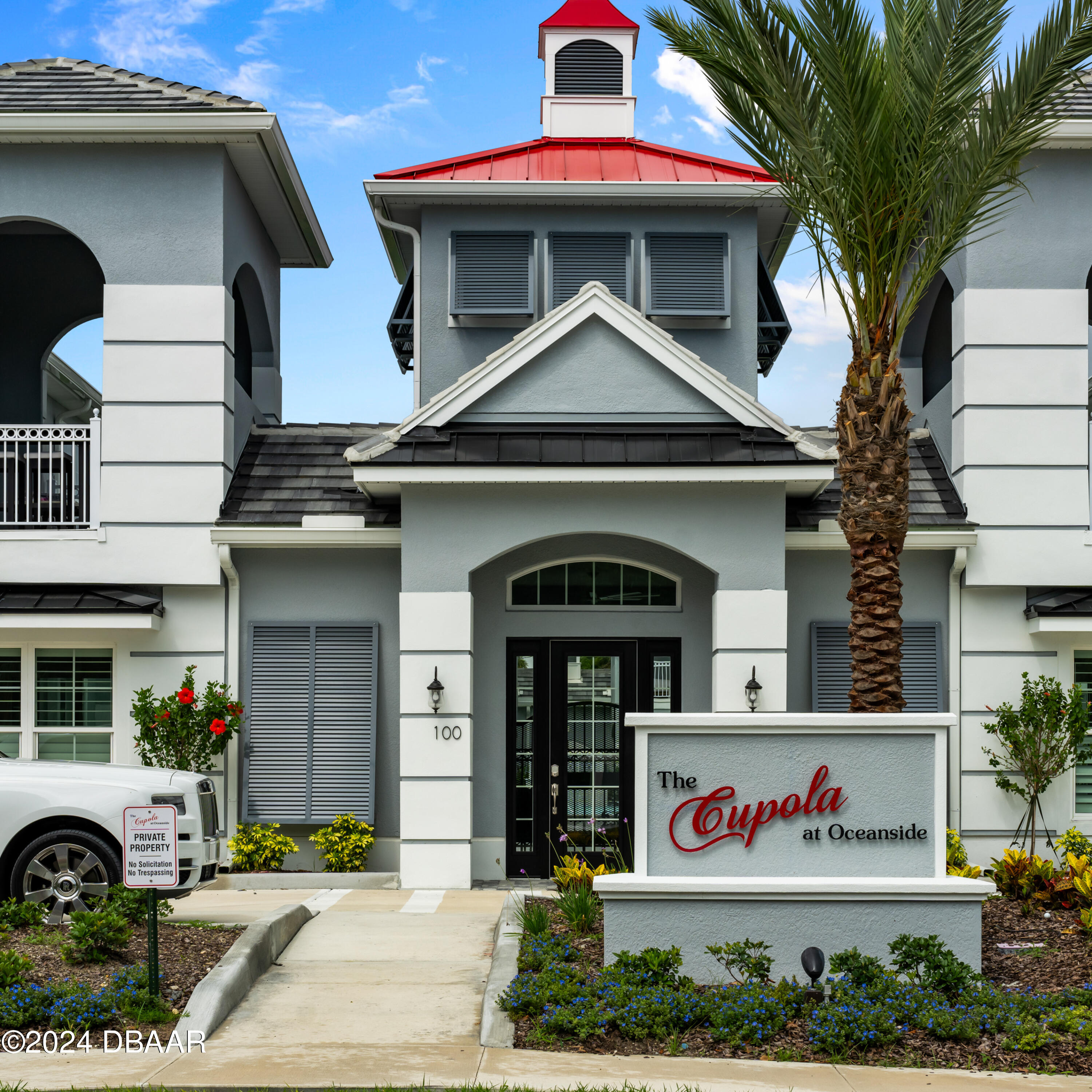 a front view of multi story residential apartment building with entryway