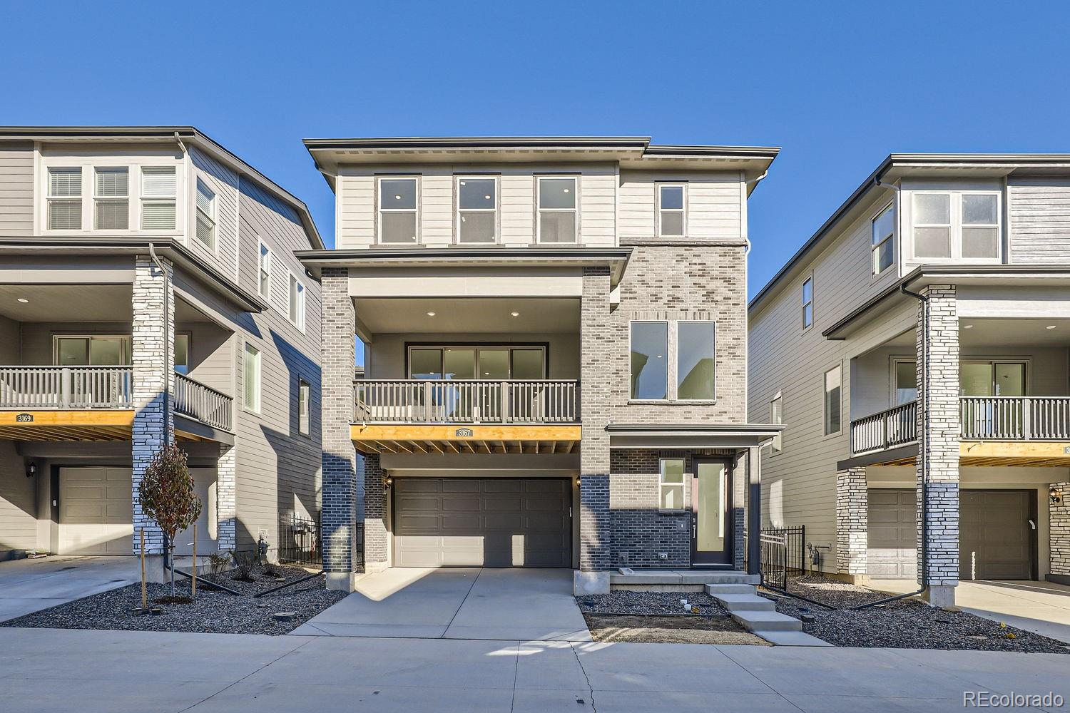 a front view of residential houses with stairs