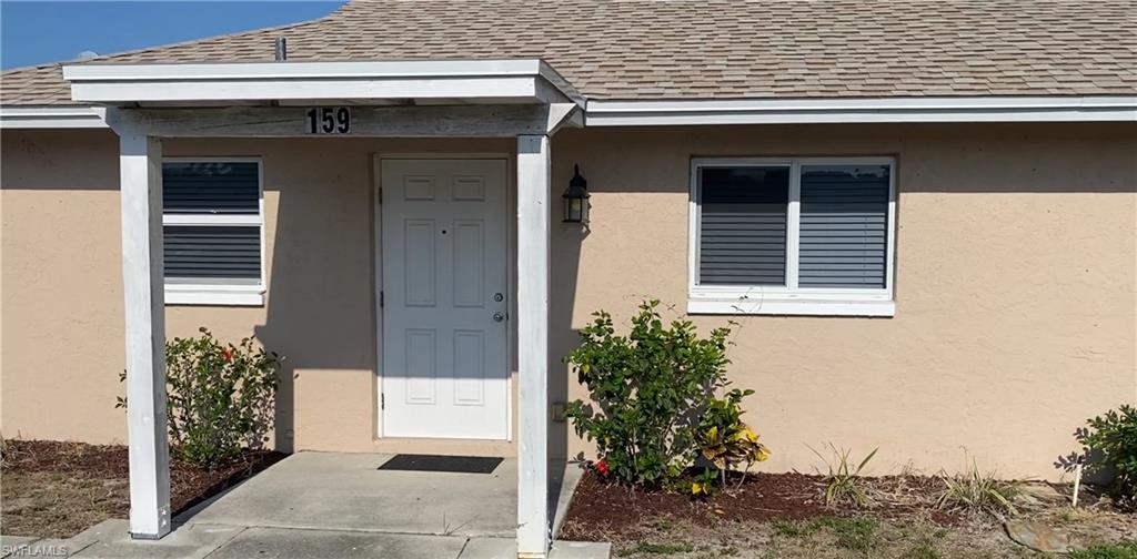 a front view of a house with plants