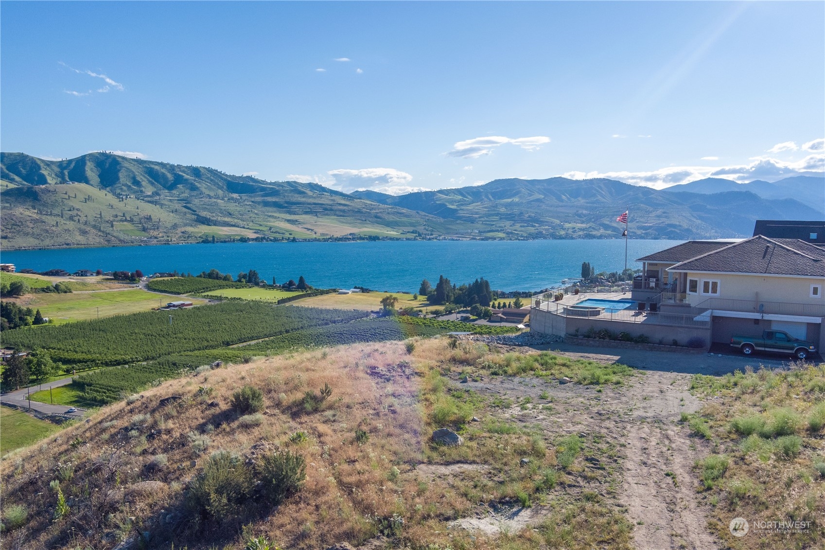 a view of a big house with a mountain in the background