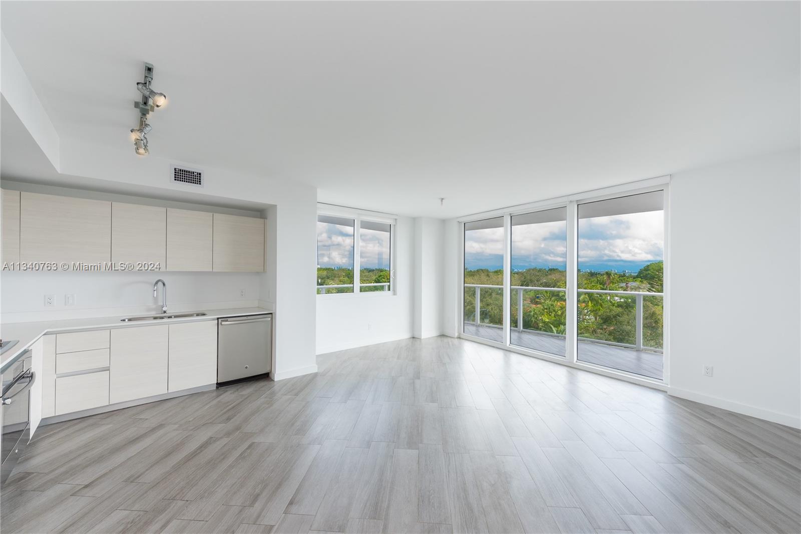 a open kitchen with wooden floor and window