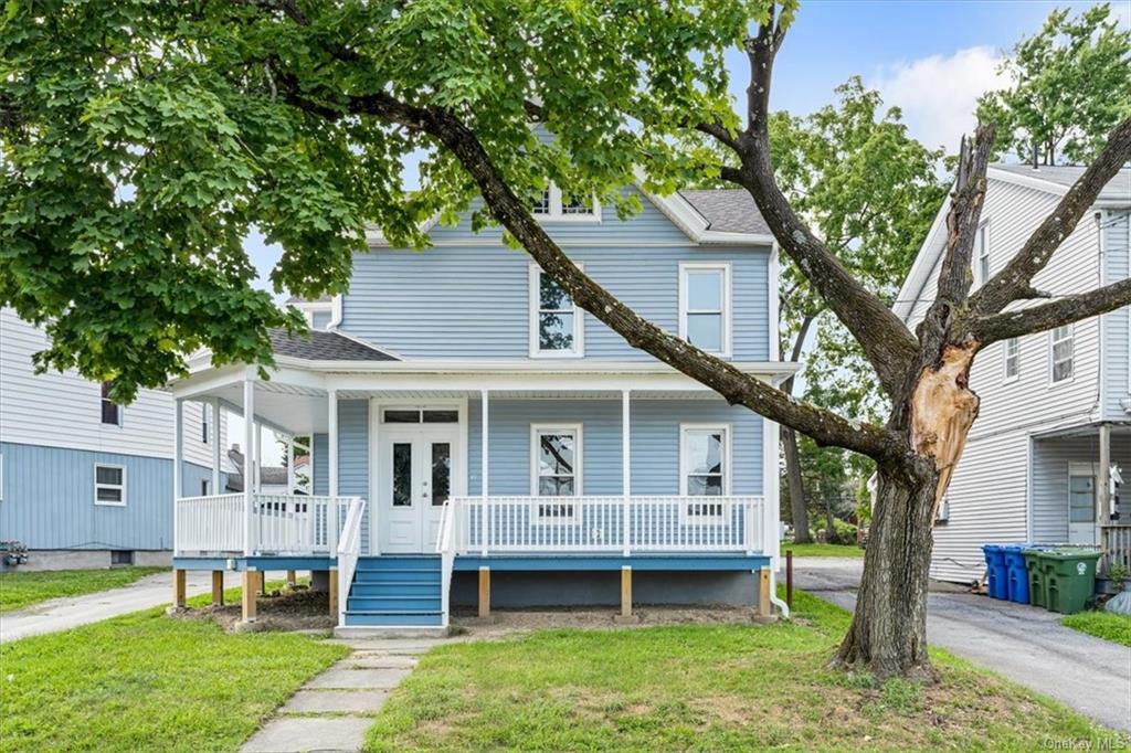 View of front facade featuring a porch and a front yard