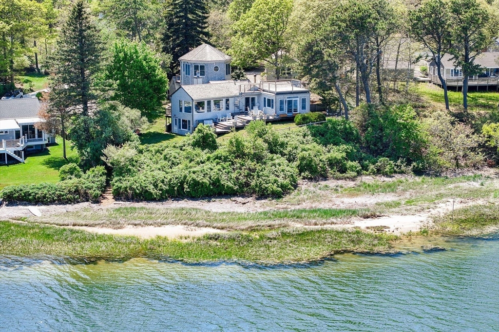 a view of a house with pool and sitting area