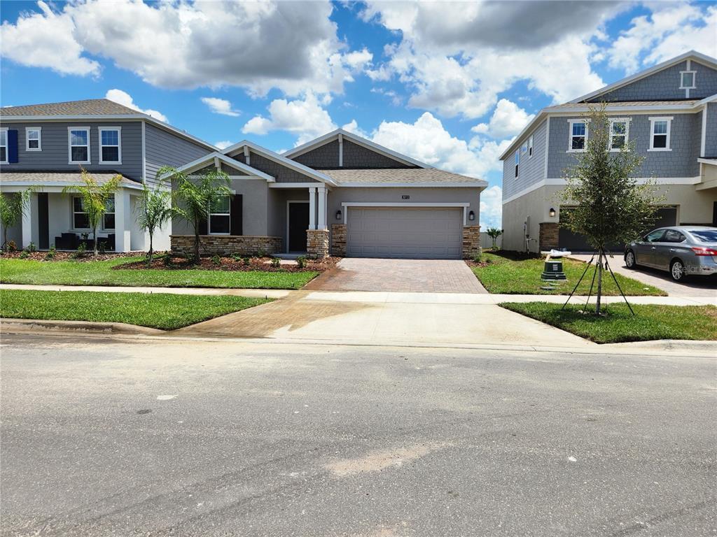 a front view of a house with a yard and garage