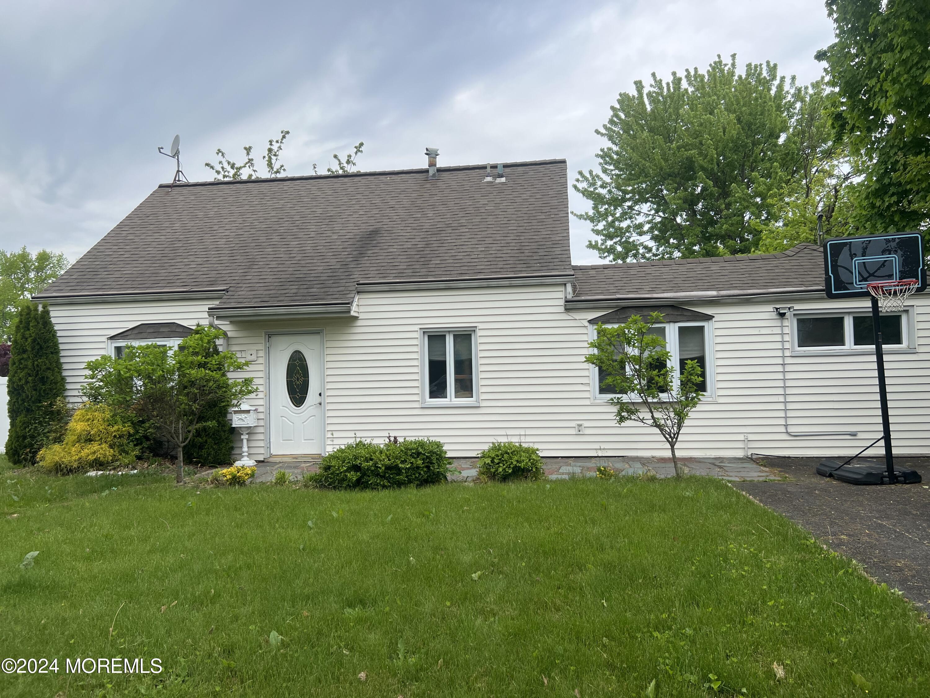 a view of a house with a yard and a garden