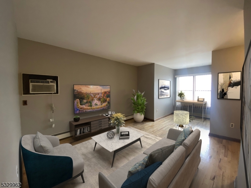 a living room with furniture couches and a flat screen tv