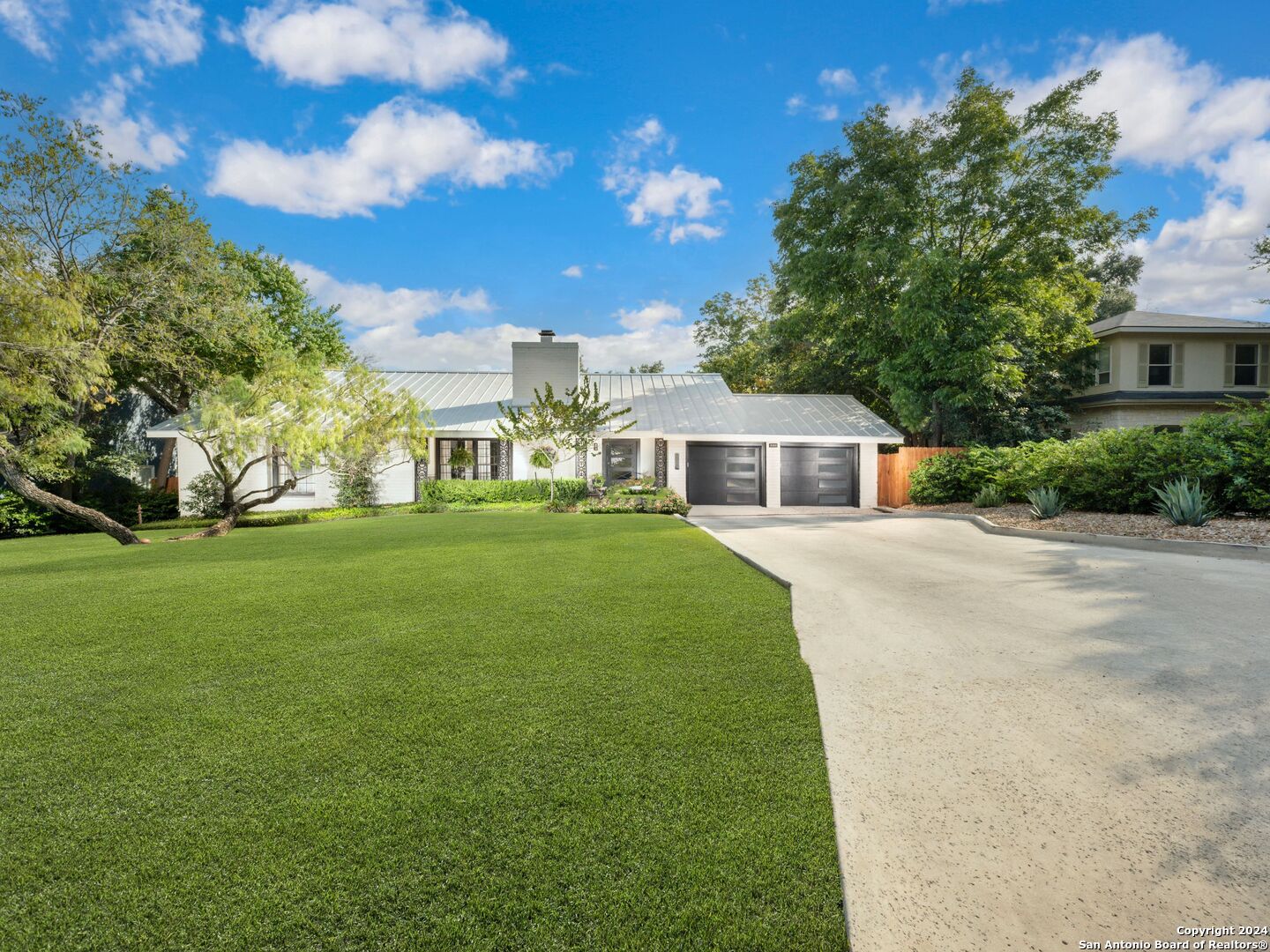 a front view of house with yard and green space