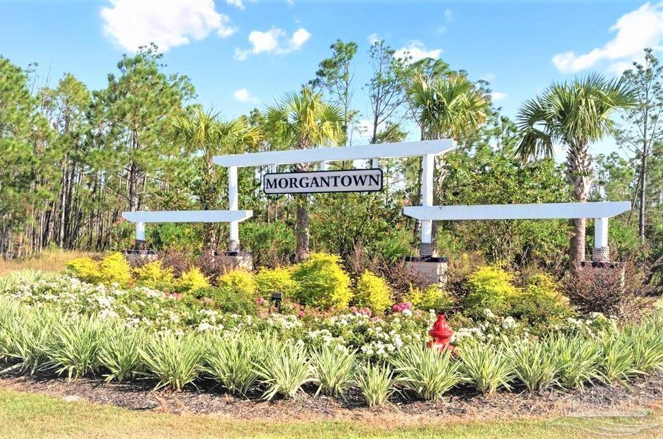 a sign that is in front of flowers