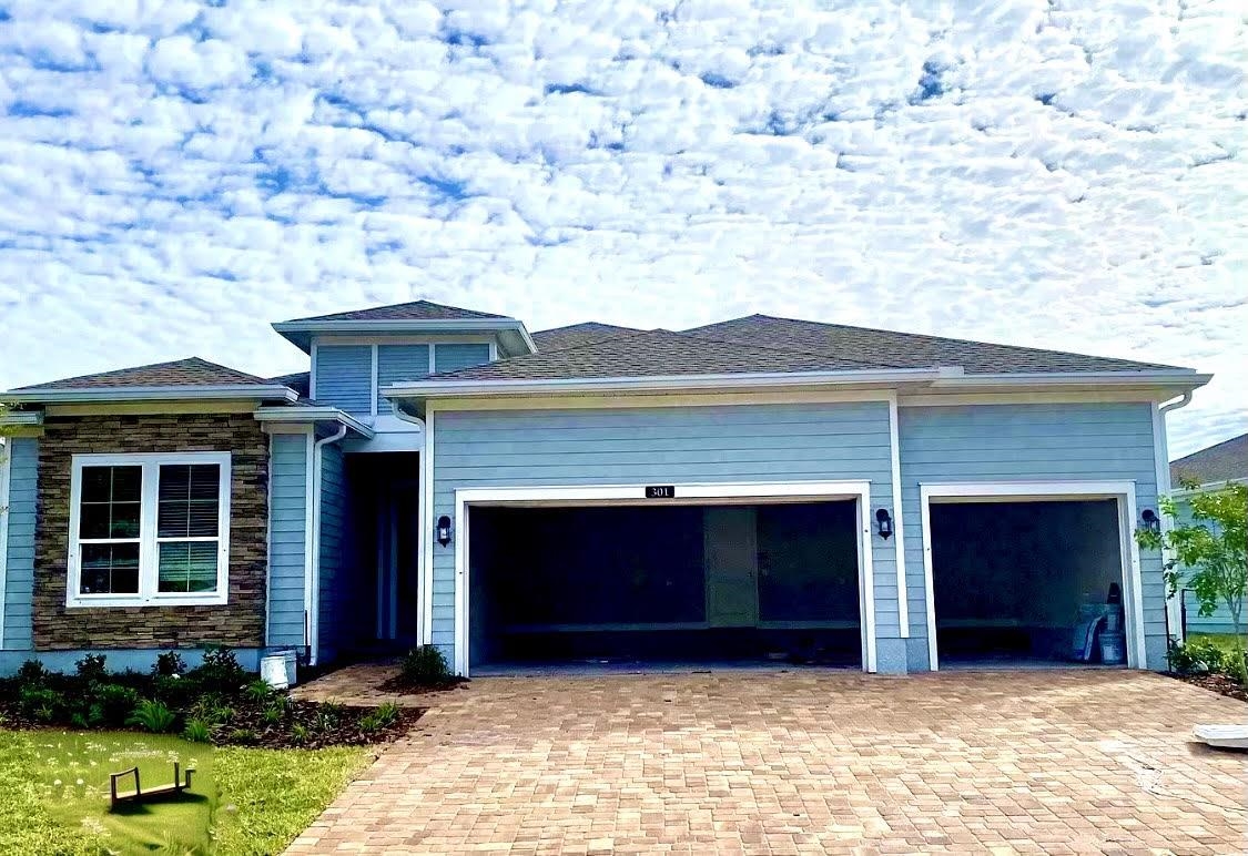 a front view of a house with a yard garage and outdoor seating