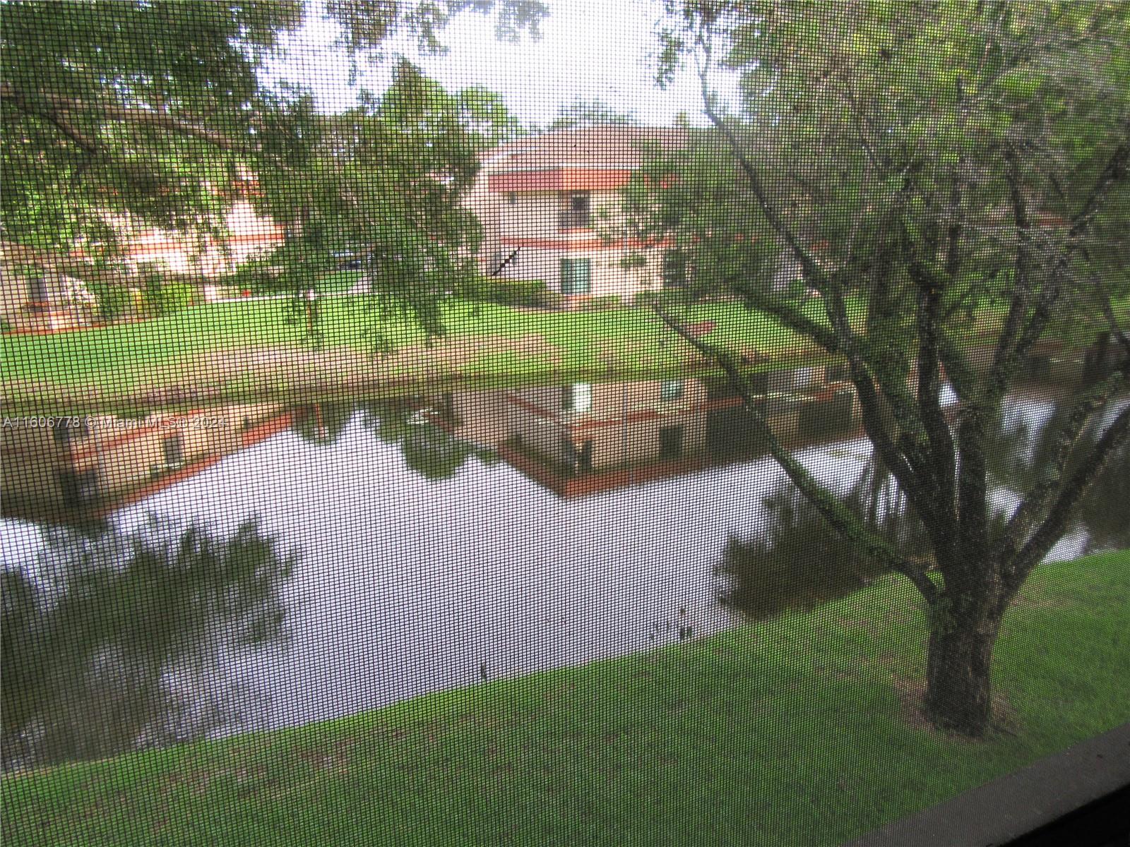 a view of a lake with a house in the background