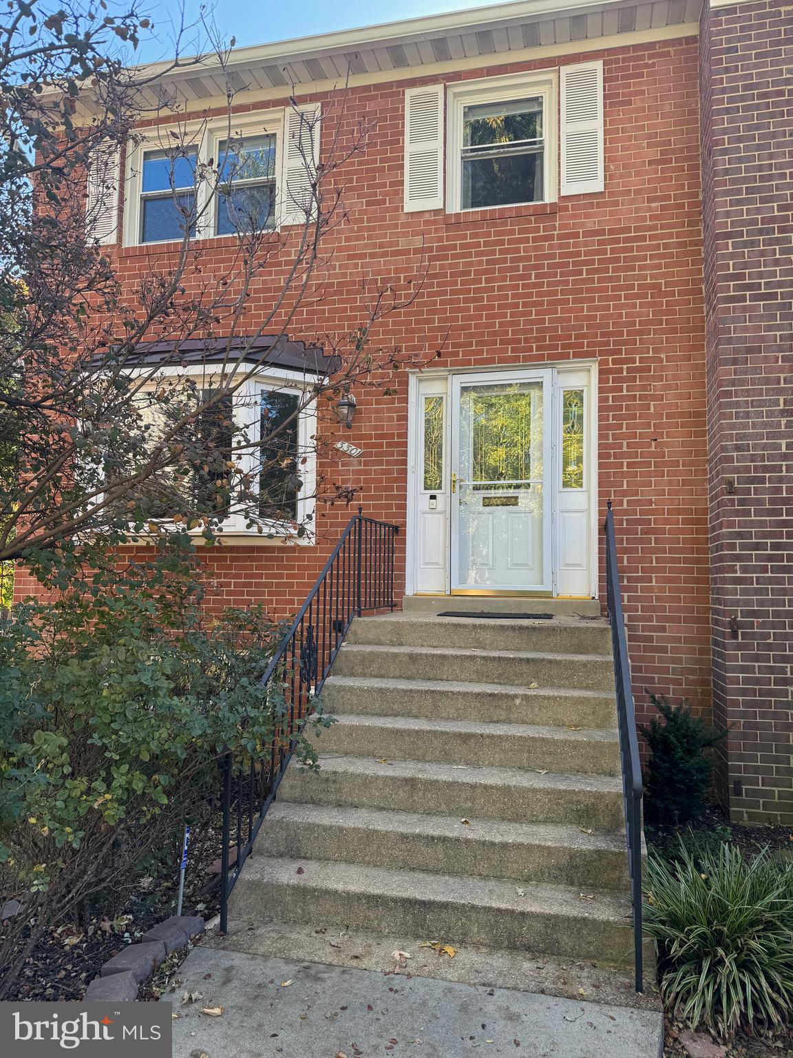 a view of a house with stairs and a yard