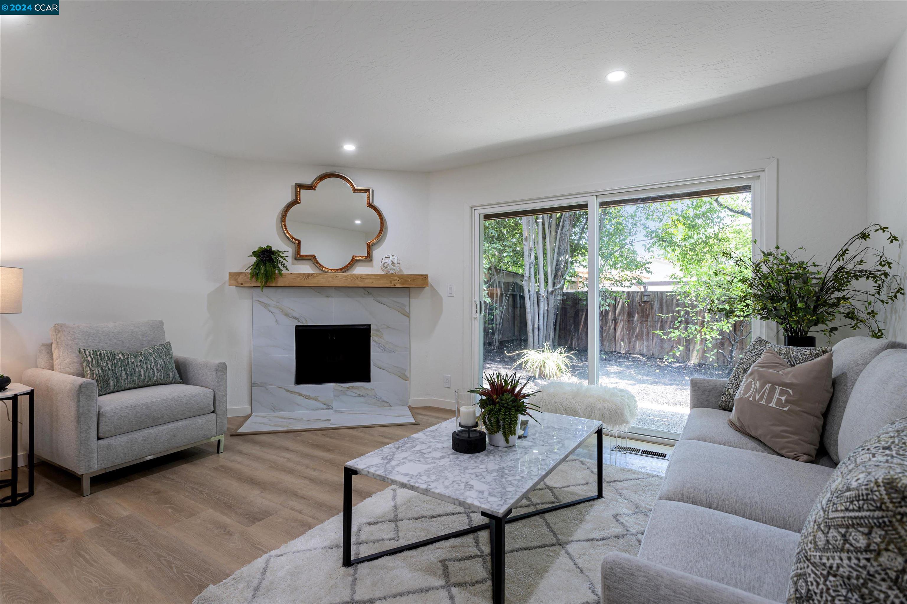 a living room with furniture and a fireplace