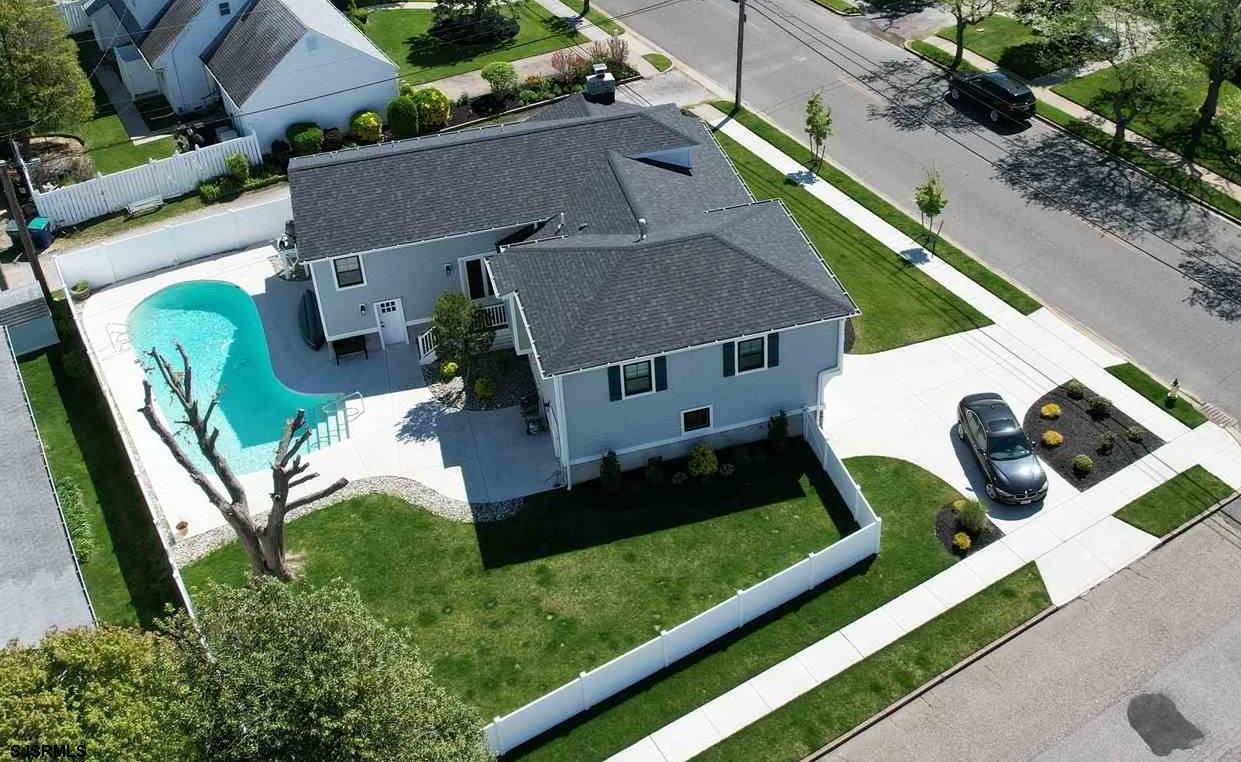 an aerial view of a house with a yard