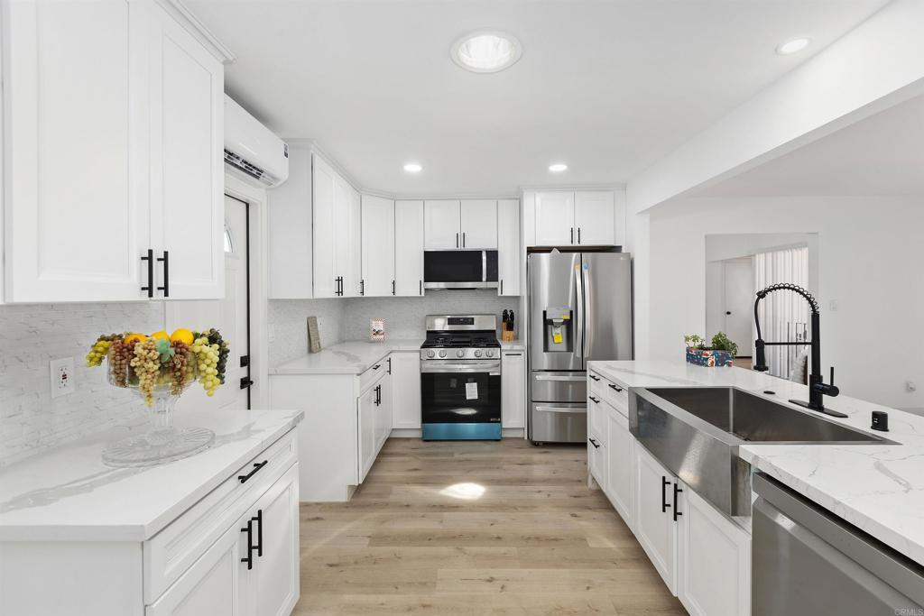 a kitchen with refrigerator a sink and cabinets