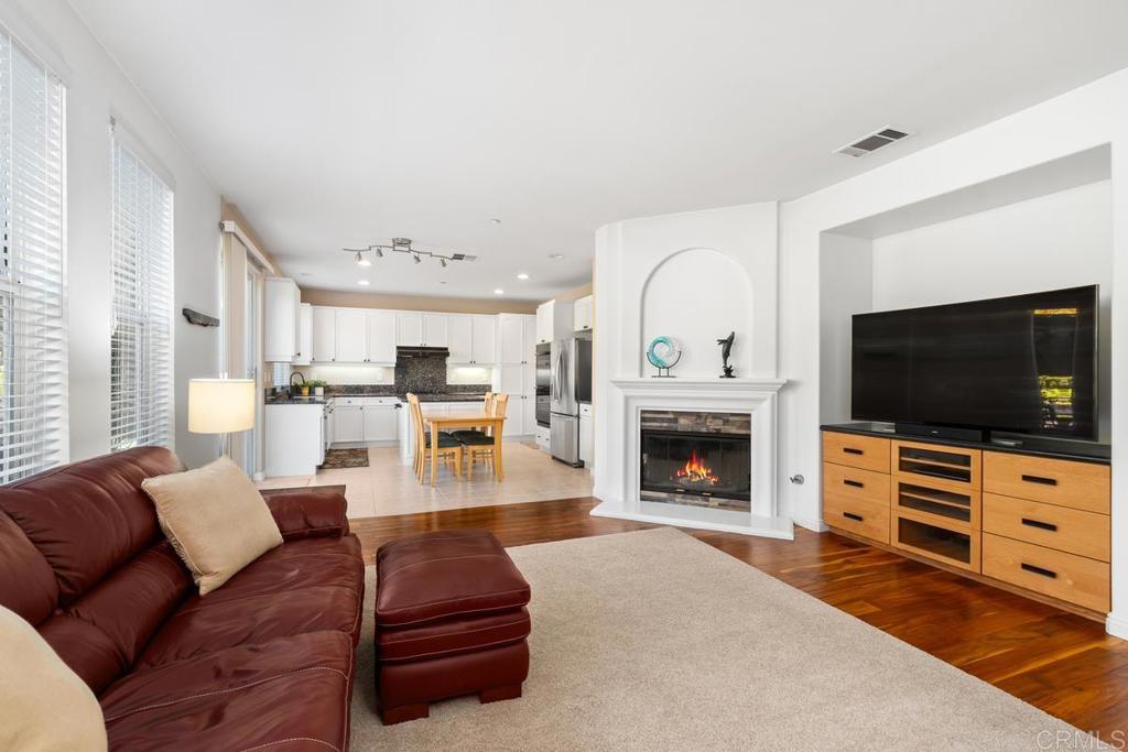 a living room with furniture flat screen tv and a fireplace