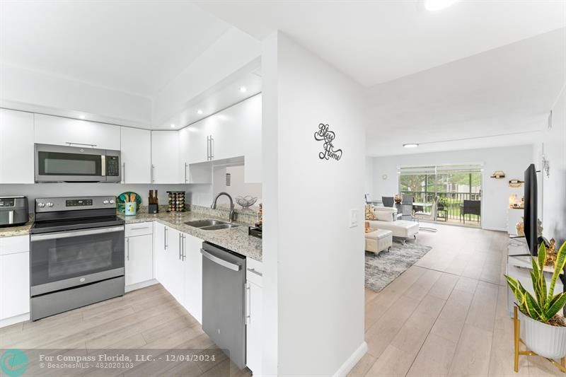 a kitchen with a stove a sink and a refrigerator