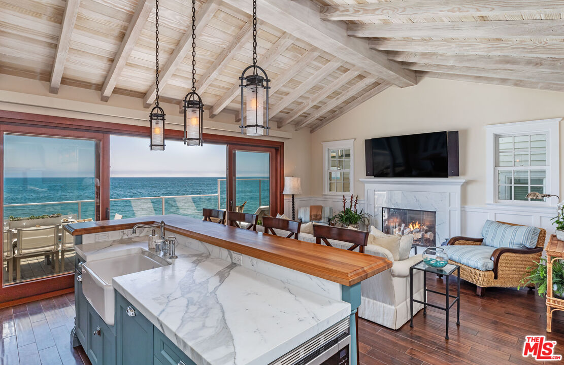 a living room with fireplace furniture and a flat screen tv