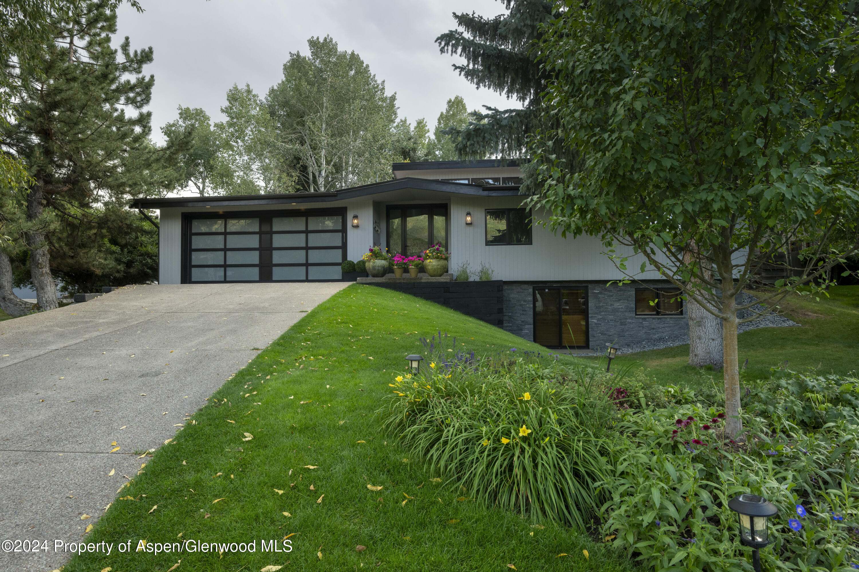 a front view of house with yard and trees