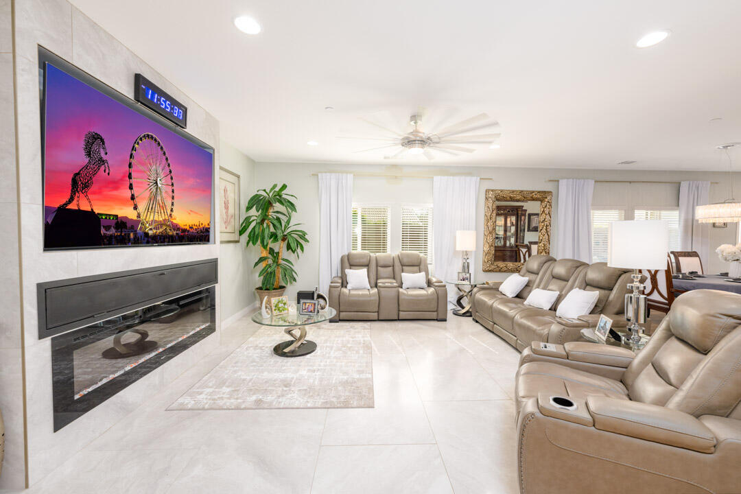 a living room with furniture gym equipment and a flat screen tv