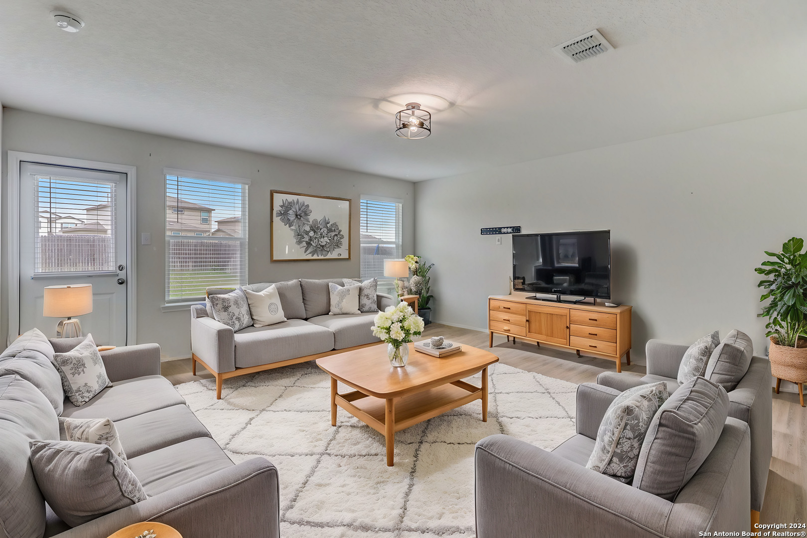 a living room with furniture a ceiling fan and a window