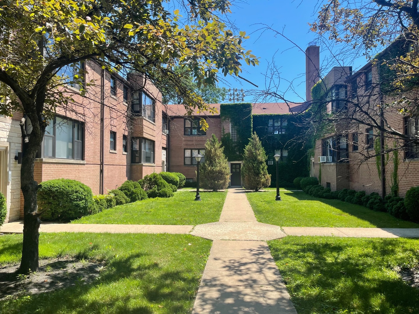 a front view of a house with yard and green space