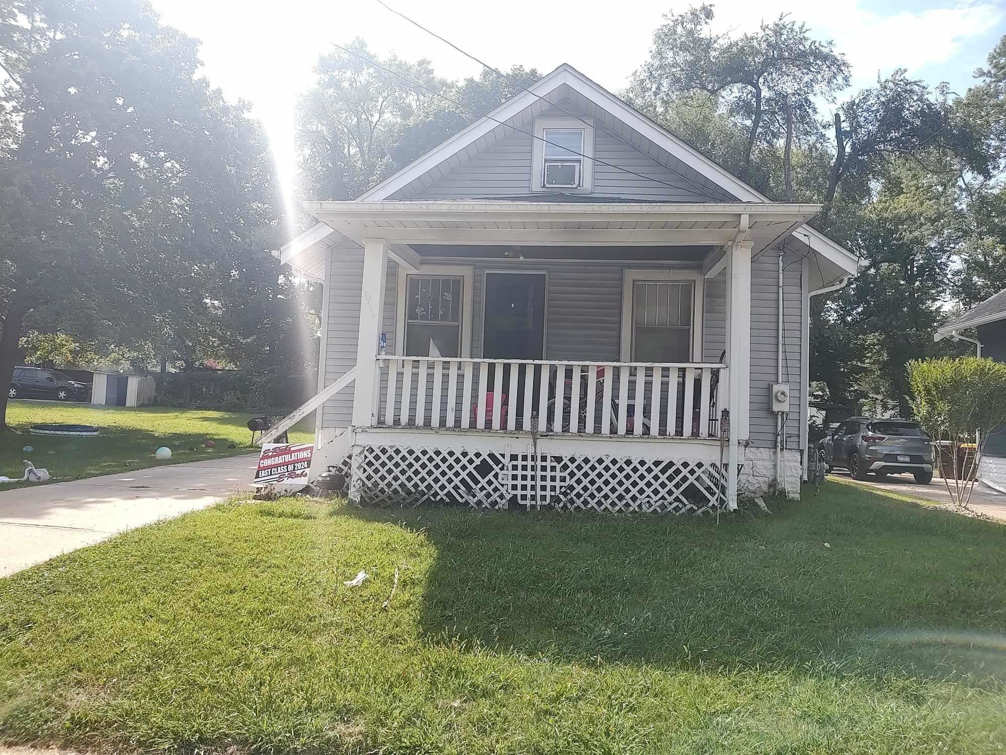 a front view of a house with garden and porch