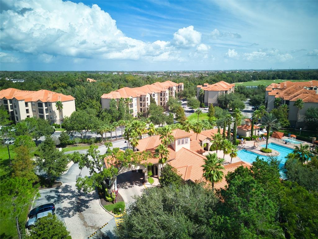 an aerial view of residential houses with outdoor space and trees